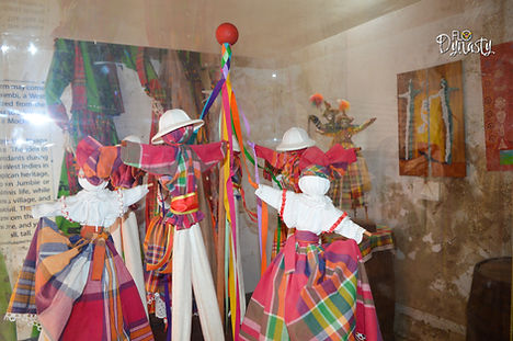Mocko Jumbies Stick Figures on Display at the fort in madras attire