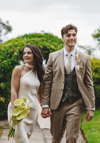 couple walking in gardens after getting married