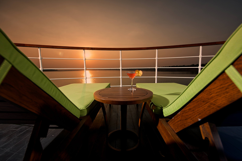 View from a river cruise deck overlooking the water at dusk.