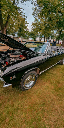 Black classic convertible with the hood open at the Alexandria Fairgrounds car show