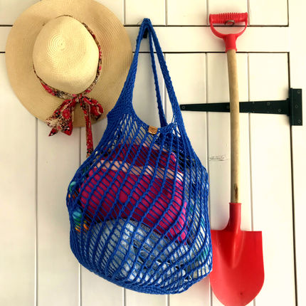 Blue knitted beach bag with long shoulder straps