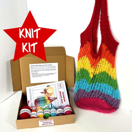 Rainbow beach bag knit kit showing yarn, needles and pattern in their box plus finished bag