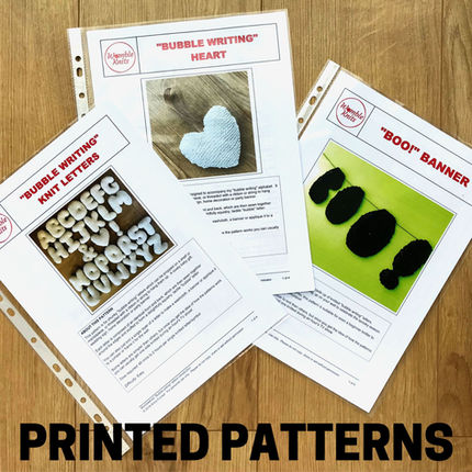 Colour printed knitting patterns displayed in recycled plastic wallets