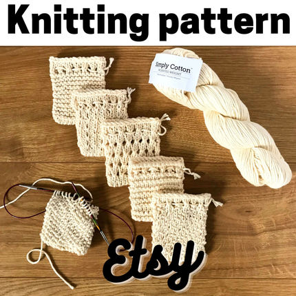 6 undyed cotton soap saver sacks with a skein of simply cotton, one sack still on the needles