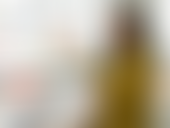 A South African marketing strategist standing beside a panel showing map pins, review stars, and listing elements, with a desk of photos and Google Post mockups in front of her. The scene illustrates practical steps to improve a Google Business Profile for Johannesburg visibility.