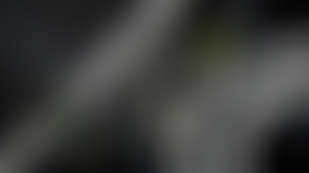 Top-down dark hero image with an abstract data intersection, small figures, and a tablet showing analytics for an AI marketing guide.