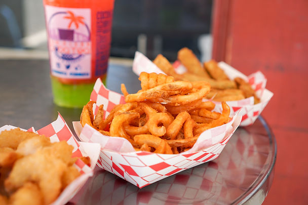 Picture of Shrimp Basket, Curly Fires, and Egg Rolls in checkered basket and a Strawberry Slush with Green Apple Jelly Drink