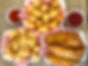 Picture with tater tots, chicken tenders, shrimp basket and ketchup dipping sauce in checkered basket