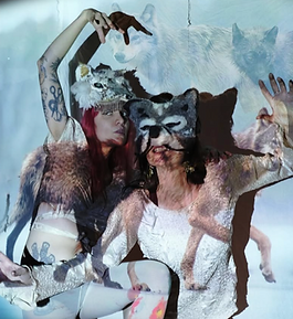 Two people dressed as Wolves posing like animals.