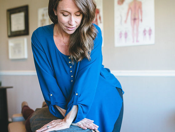 Dr. Liz adjusts a patient