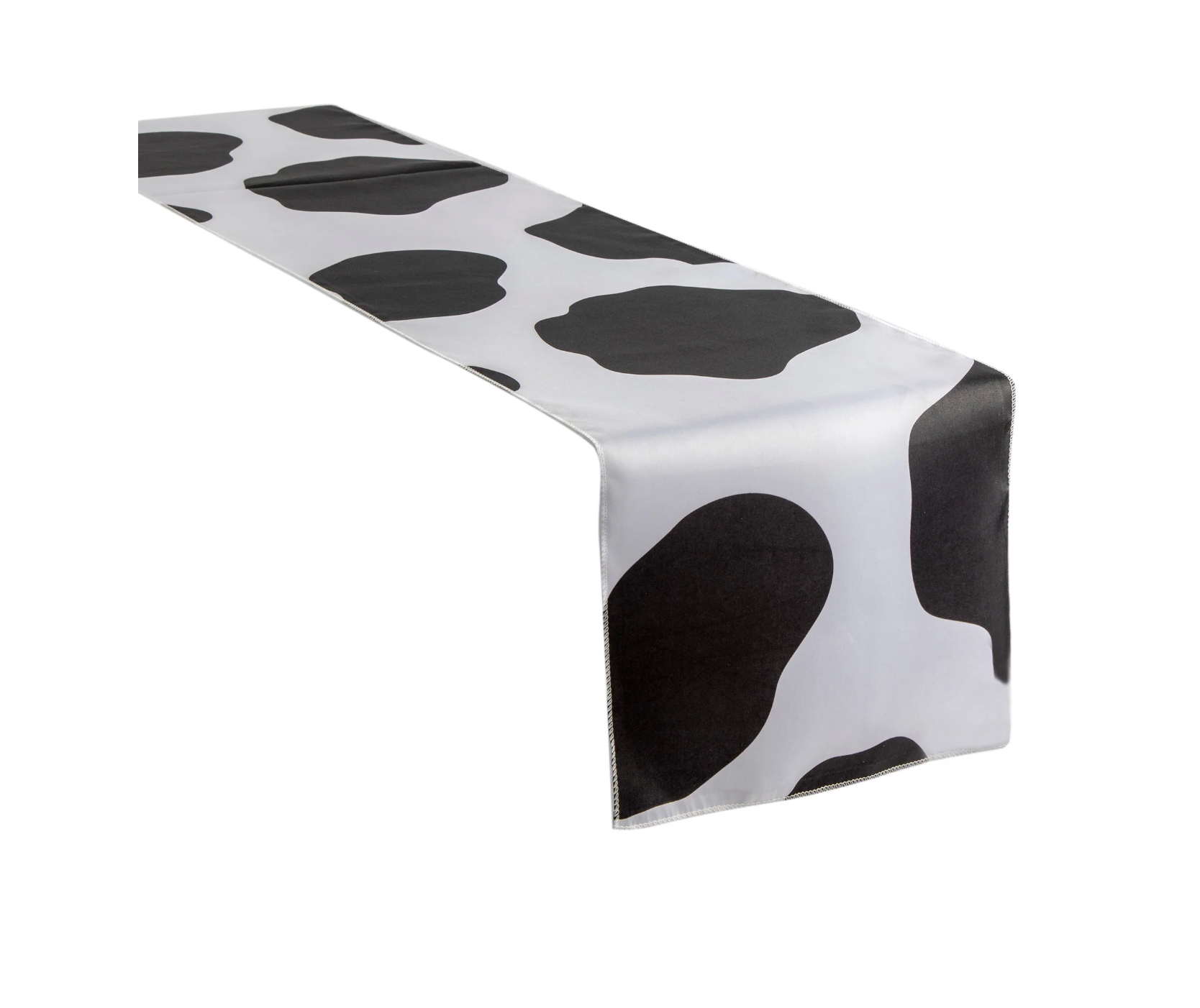 A white and black runner in the pattern of cow print