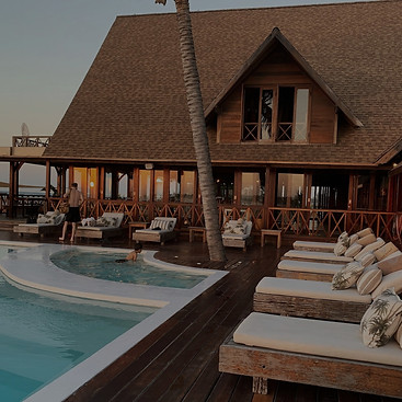 A captivating view of the resort's pool area, showcasing a serene oasis for relaxation and enjoyment. In the foreground, poolside loungers are meticulously arranged, inviting guests to recline and bask in the sun.