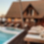 A captivating view of the resort's pool area, showcasing a serene oasis for relaxation and enjoyment. In the foreground, poolside loungers are meticulously arranged, inviting guests to recline and bask in the sun.