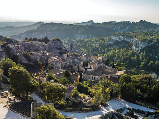Scenic view of Les Baux-de-Provence AOC located in Provence wine region. The medieval village is surrounded by vineyards, olive groves, and picturesque landscapes