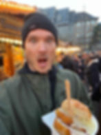 Strasbourg man holding cheese sandwich in winter