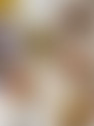 Assorted Mediterranean dishes on a white table: falafel, hummus, olives, flatbread, and a lit candle creating a cozy dining vibe.