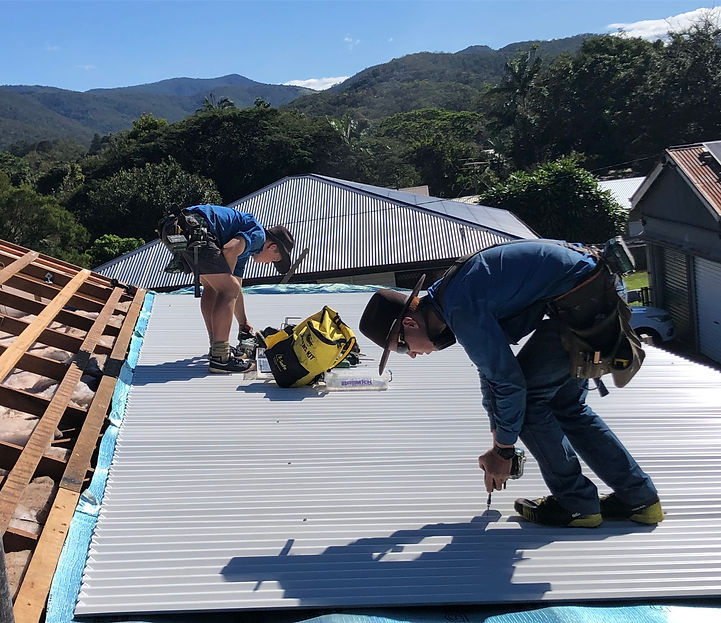 Two roofing contractors dooing a re-roof in town.
