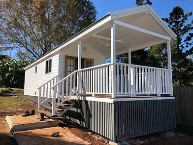 White Modular house with a large timber deck