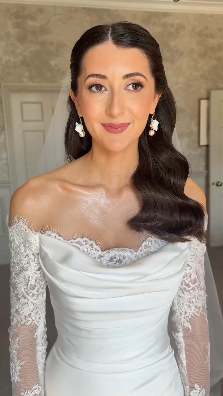 Bride with glossy sculpted waves and a lace gown