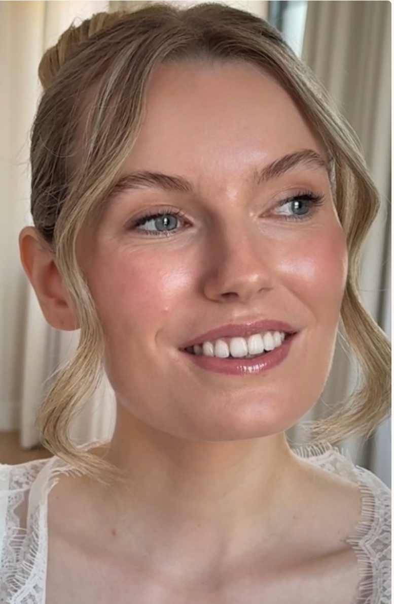 Glowing bridal makeup with soft face-framing blonde hair