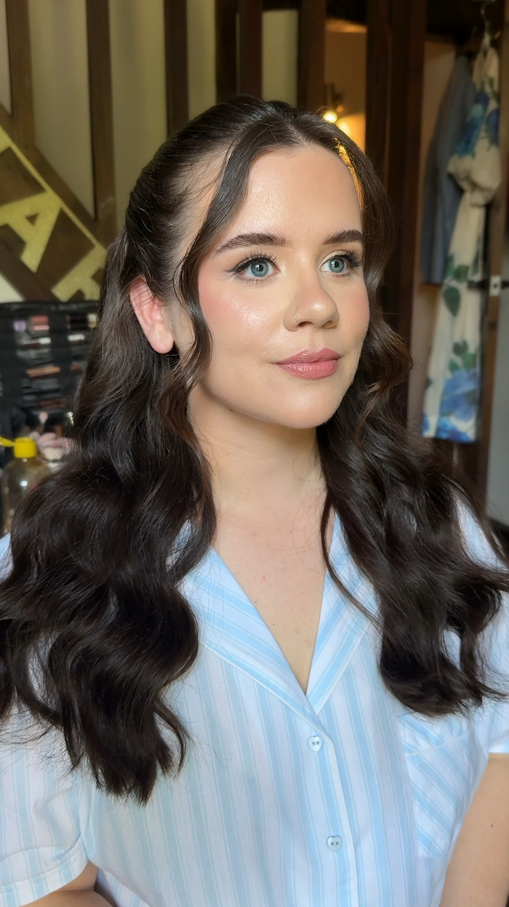 Bride with dark Hollywood-style waves and a soft pink lip