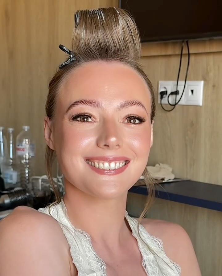 A Holly Ann Bridal bride in Greece with a high bun and glowing skin