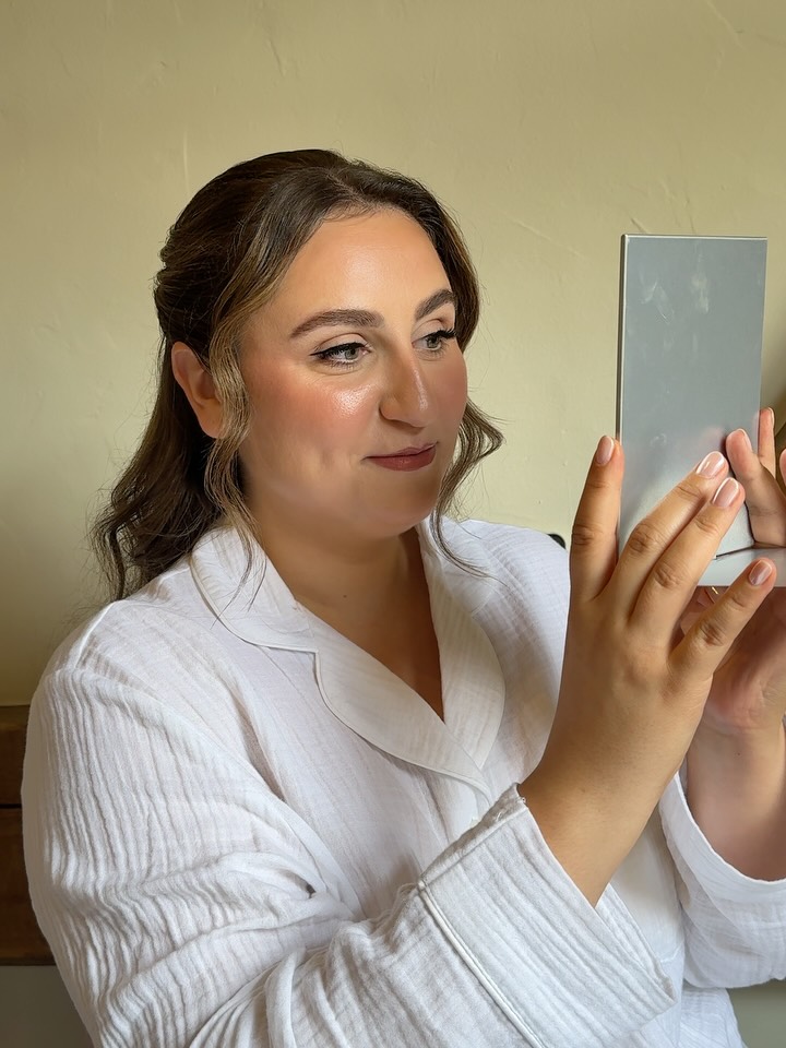 Bride with a sleek middle part and natural glowing makeup