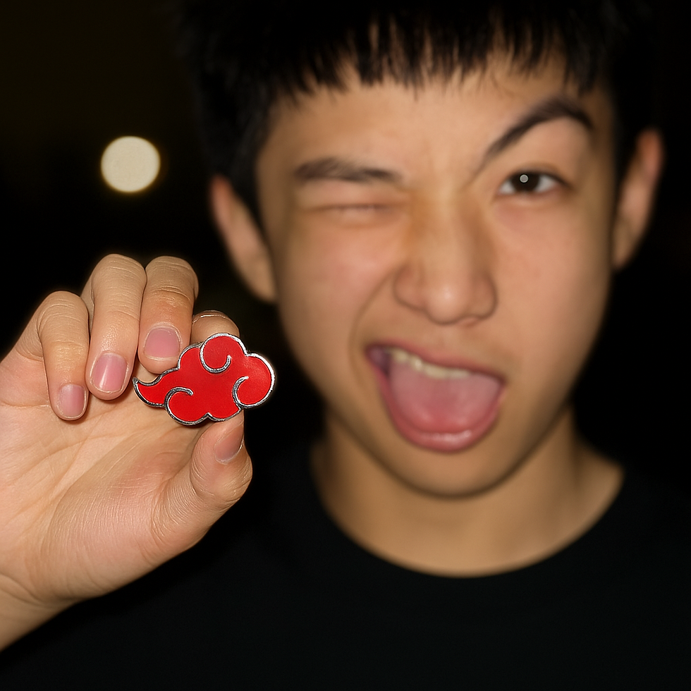 Young man winking and holding up a red Naruto Akatsuki Cloud enamel pin, showing how to wear anime enamel pins with Goldenord collectible fashion accessories for trendy outfits.