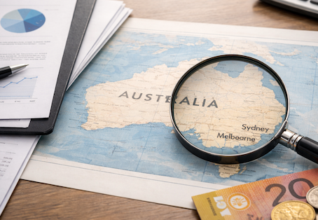 Unclaimed money in Australia concept showing financial documents and magnifying glass over Australia map