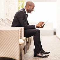 Man reading newsletter on his tablet