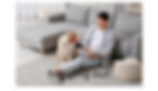 man reading book and hanging out with dog sitting on the floor