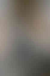 Lady holds bat in hand after smashing a TV in a self built rage room