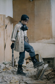 Lady holds bat in hand after smashing a TV in a self built rage room