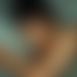 Beautiful African- American lady soundly sleeping on a green pillow and sheet