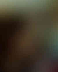 Man relaxes and smokes while watching a movie to take his mind off the everyday stress