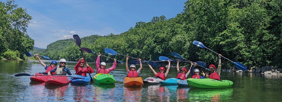 summer campers in kayaks on the river