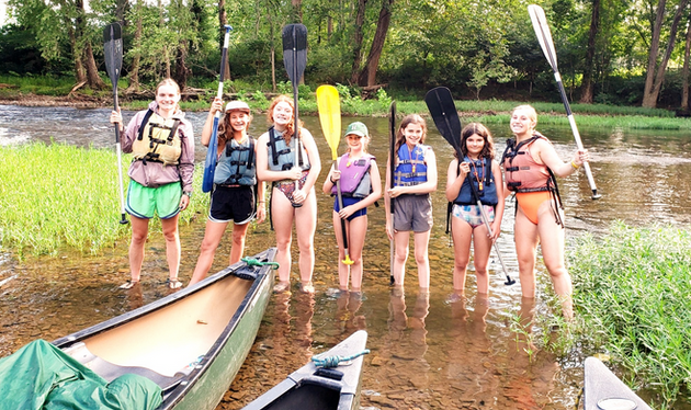 campers canoeing at summer camp girls camp