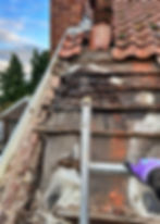 roofer fixing a damaged tiled roof.