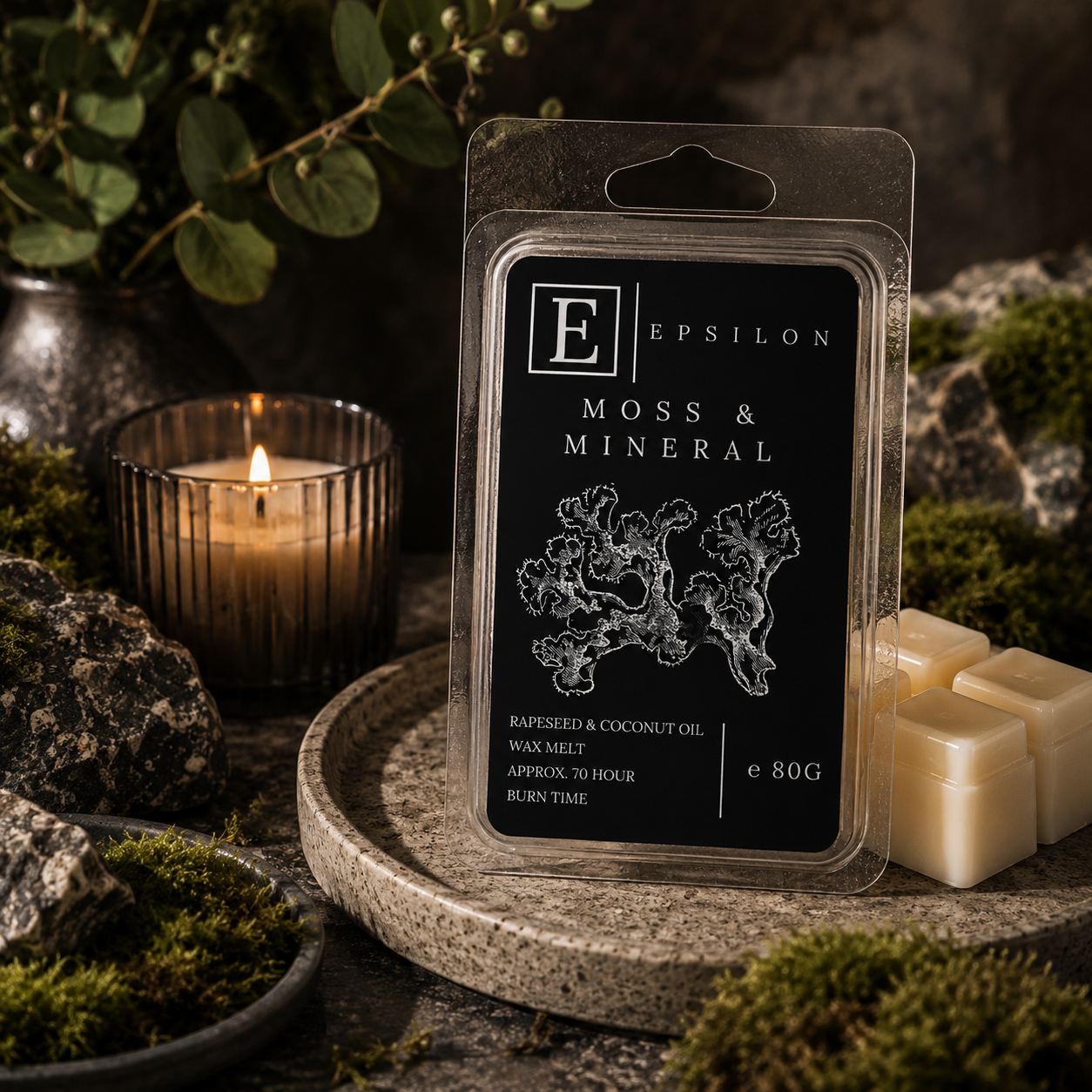 Epsilon Home Moss & Mineral wax melt in an earthy setting with natural stone, green moss, foliage and warm candlelight