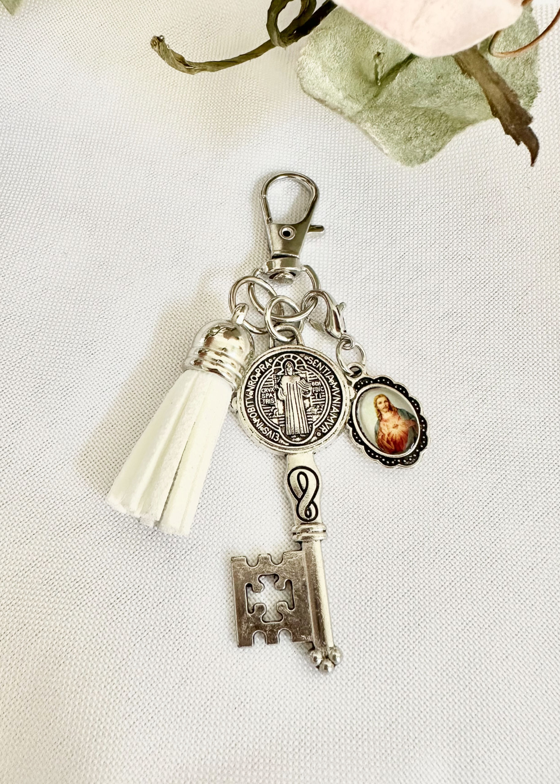 St. Benedict Key Charm with Sacred Heart Pendant — silver-tone St. Benedict key charm with key, Sacred Heart pendant, and white tassel