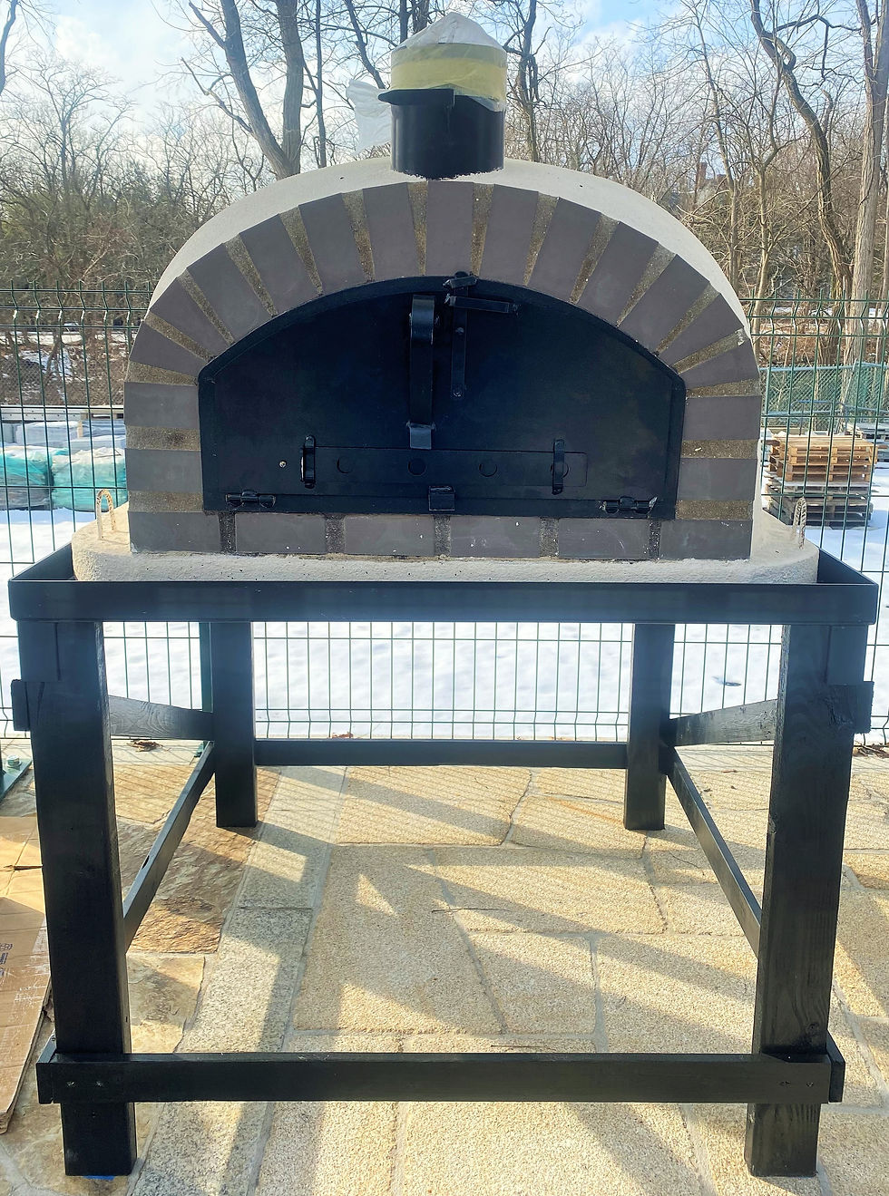 Miniatura: Horno de pizza de madera mariposa con arco de ladrillo negro y acabado de estuco
