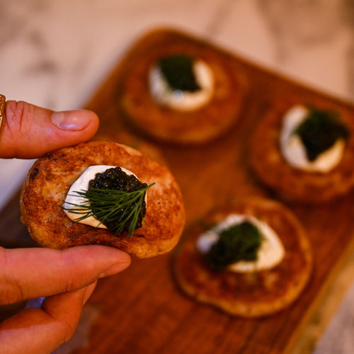 Oladky Ukrainian pancakes topped with black caviar and dill