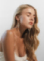 Model wearing chain mesh dangle statement earrings