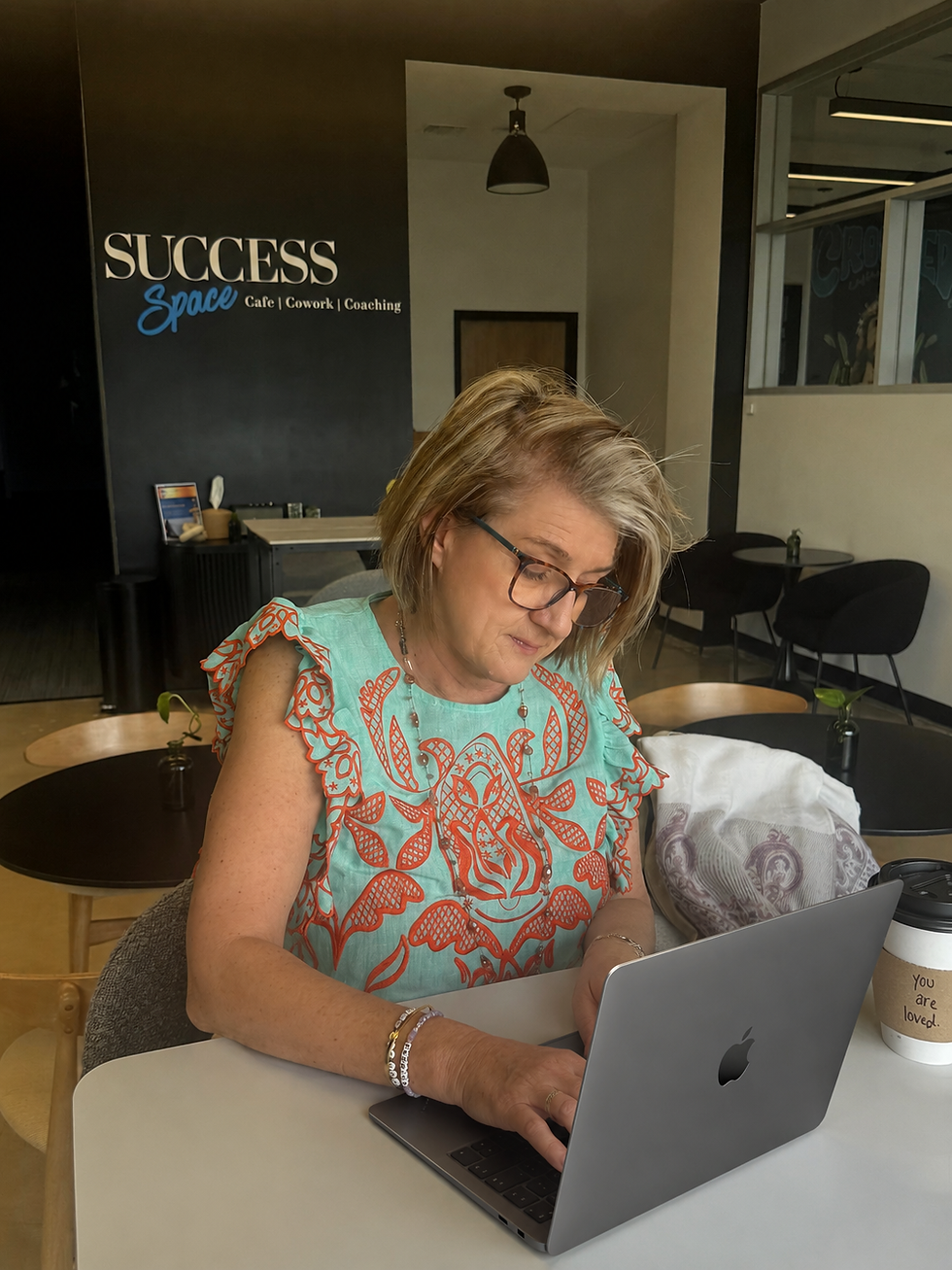 Sue Borst working on website messaging clarity at Success Space cowork cafe in San Antonio