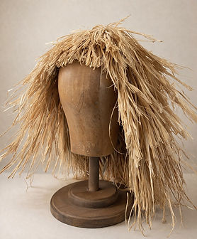 Wooden mannequin head with straw fringe.jpeg