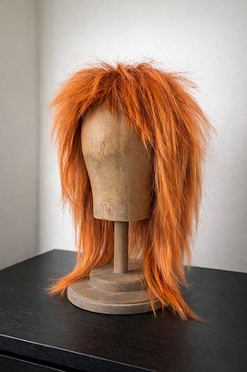 Shaggy orange wig on mannequin head.jpeg