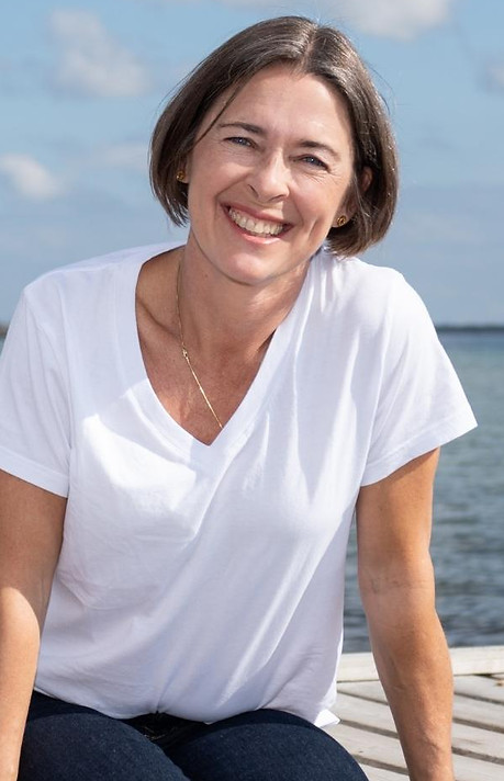 PIcture of Fiona from Bodywisdom smiling in front of the ocean