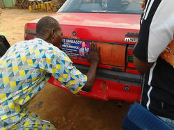 A taxi driver pasting the sticker