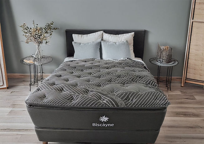 Image of Black Mattress with white stripes on a bedframe with a stand on both sides of the bedframe.