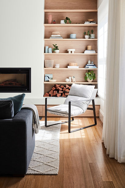 CUSTOM TIMBER BOOKSHELVES, AN OCCASIONAL CHAIR AND CURTAINS